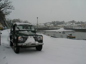 Saundersfoot harbour in heavy snow - Land Rover in the foreground